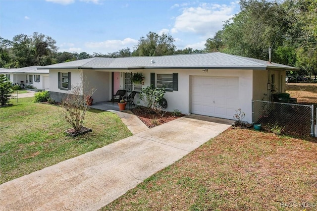 single story home featuring a garage, fence, driveway, and stucco siding