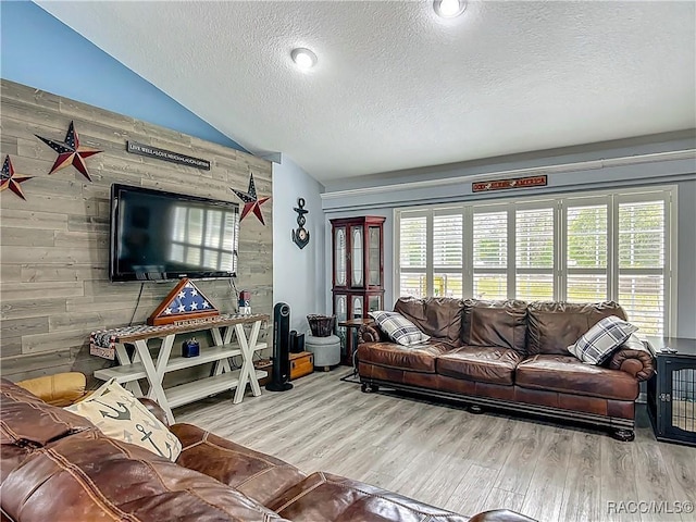 2478 W Angola Dr, Beverly Hills, FL 34465 - living room featuring a textured ceiling, lofted ceiling, wood finished floors, and wood walls