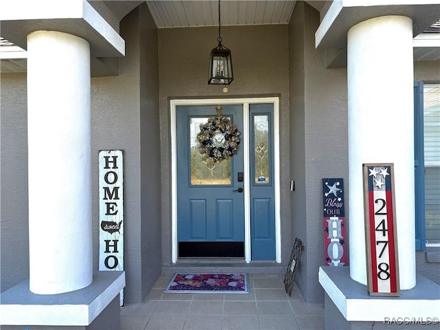 view of exterior entry featuring stucco siding