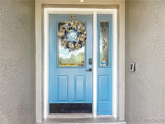2478 W Angola Dr, Beverly Hills, FL 34465 - doorway to property with stucco siding