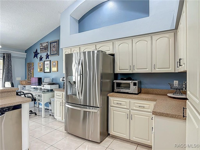 2478 W Angola Dr, Beverly Hills, FL 34465 - kitchen with appliances with stainless steel finishes, vaulted ceiling, light tile patterned floors, a desk, and a textured ceiling