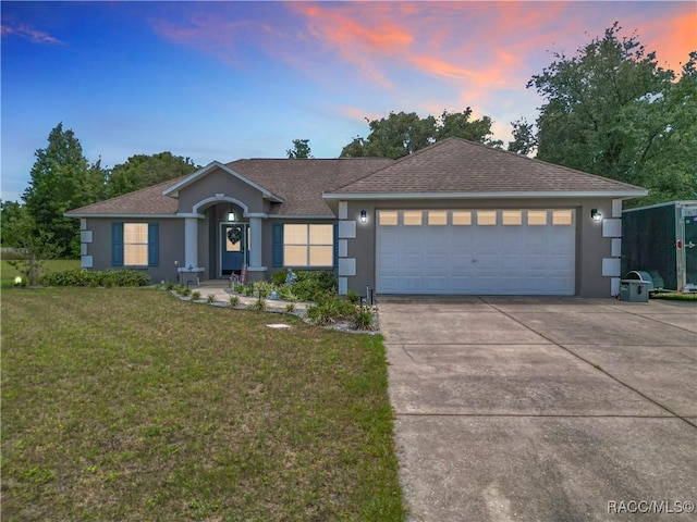 2478 W Angola Dr, Beverly Hills, FL 34465 - ranch-style house with stucco siding, concrete driveway, a front yard, a garage, and a shingled roof