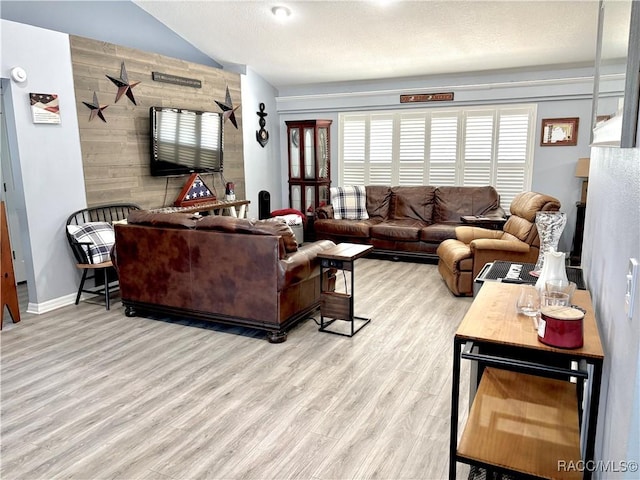 2478 W Angola Dr, Beverly Hills, FL 34465 - living room featuring wood finished floors, vaulted ceiling, and a textured ceiling