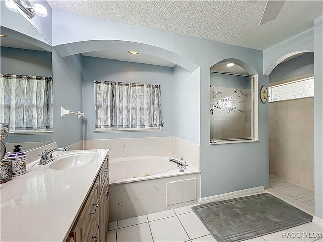 2478 W Angola Dr, Beverly Hills, FL 34465 - bathroom featuring a tub with jets, tile patterned floors, vanity, walk in shower, and a textured ceiling