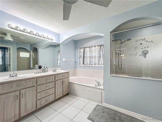 2478 W Angola Dr, Beverly Hills, FL 34465 - full bathroom featuring a ceiling fan, a bath, a tile shower, tile patterned floors, and double vanity