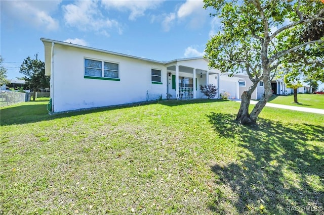 single story home with covered porch, stucco siding, and a front yard