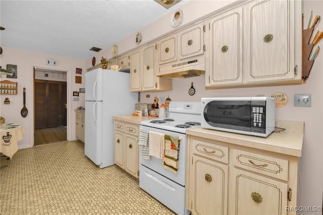 kitchen with visible vents, under cabinet range hood, cream cabinets, white appliances, and light countertops