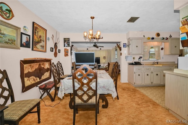 dining room with visible vents, light carpet, and ceiling fan with notable chandelier