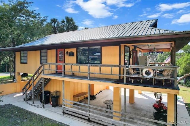 back of property with ceiling fan