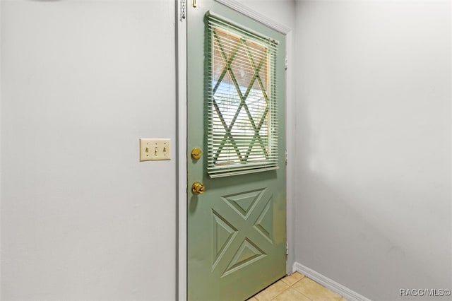 doorway to outside with light tile patterned floors