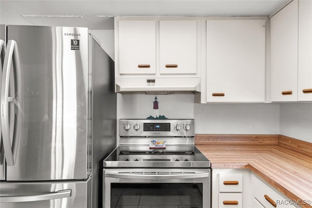 kitchen with tile patterned flooring, appliances with stainless steel finishes, and white cabinetry