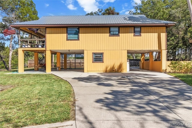 view of front of house with a front lawn and a carport