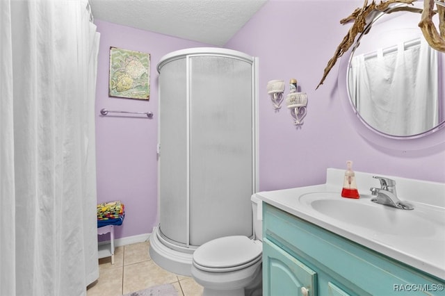 bathroom featuring tile patterned floors, a textured ceiling, toilet, vanity, and a shower with shower door