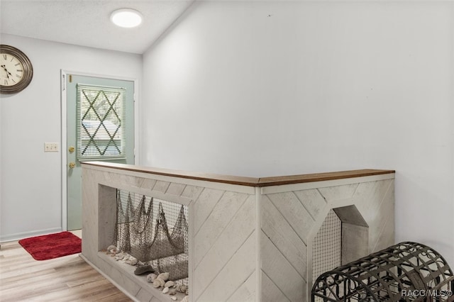 stairway featuring wood-type flooring and a textured ceiling