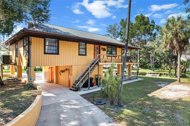 view of front of house featuring central air condition unit and a garage