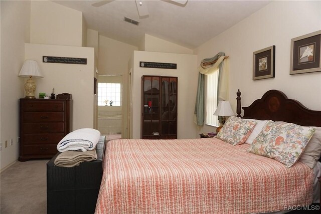 3033 N Chandler Dr, Hernando, FL 34442 - carpeted bedroom with ensuite bath, vaulted ceiling, and a ceiling fan