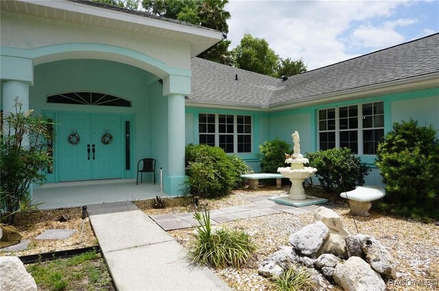 3033 N Chandler Dr, Hernando, FL 34442 - property entrance featuring roof with shingles and stucco siding