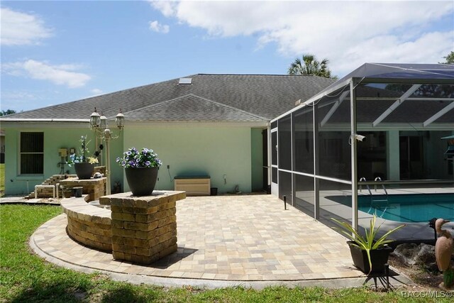 3033 N Chandler Dr, Hernando, FL 34442 - rear view of property featuring a patio, an outdoor pool, and a shingled roof