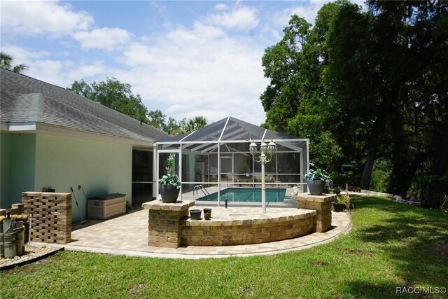 3033 N Chandler Dr, Hernando, FL 34442 - back of house with a patio area, an outdoor pool, stucco siding, a lawn, and a lanai