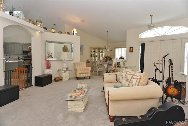 3033 N Chandler Dr, Hernando, FL 34442 - living room featuring carpet flooring, lofted ceiling, and arched walkways