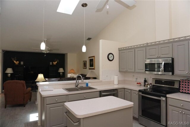 3033 N Chandler Dr, Hernando, FL 34442 - kitchen featuring appliances with stainless steel finishes, gray cabinets, ceiling fan, open floor plan, and vaulted ceiling