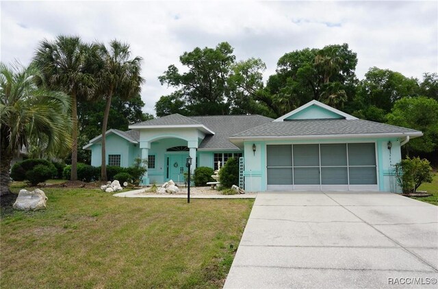 3033 N Chandler Dr, Hernando, FL 34442 - ranch-style house with an attached garage, concrete driveway, a front yard, stucco siding, and roof with shingles