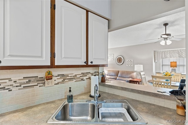 kitchen with sink, ceiling fan, a textured ceiling, tasteful backsplash, and white cabinetry