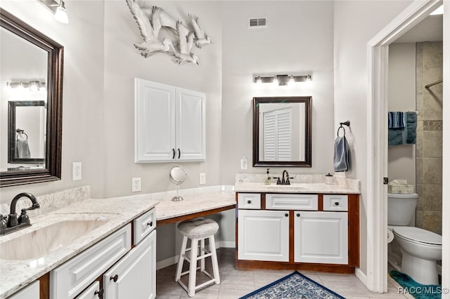 bathroom featuring tile patterned floors, vanity, and toilet