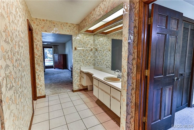 bathroom with tile patterned floors and vanity