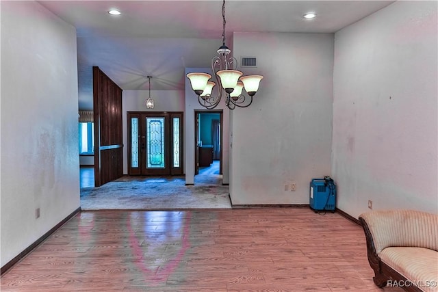 interior space featuring a chandelier and light hardwood / wood-style floors