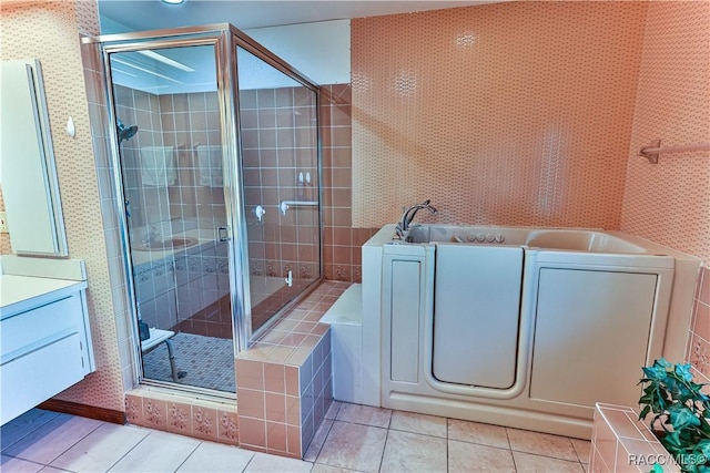 bathroom featuring tile patterned flooring, vanity, and walk in shower