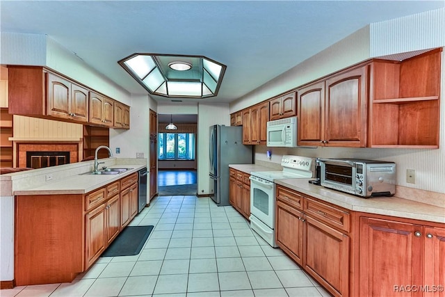 kitchen featuring white appliances, sink, and light tile patterned floors