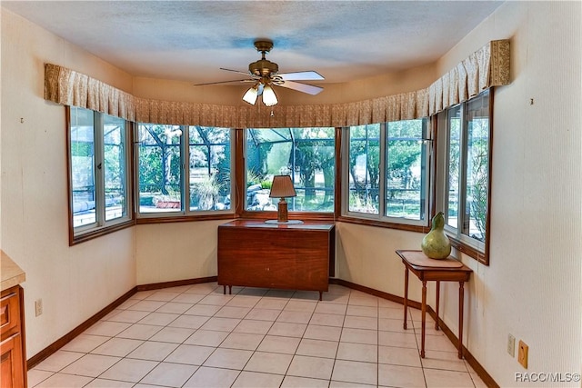 sunroom / solarium featuring ceiling fan