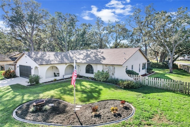 view of front of house featuring a front yard and a garage