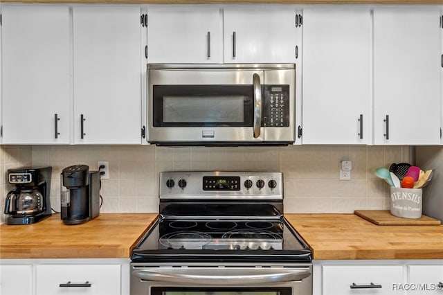 kitchen with white cabinets, stainless steel appliances, and tasteful backsplash