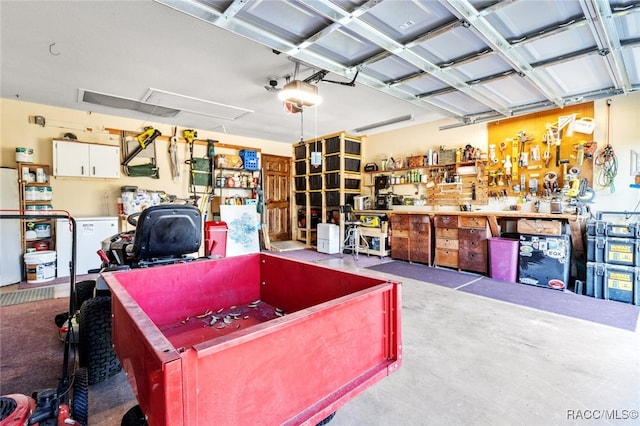 garage with a workshop area and a garage door opener