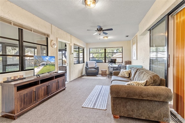 sunroom featuring ceiling fan