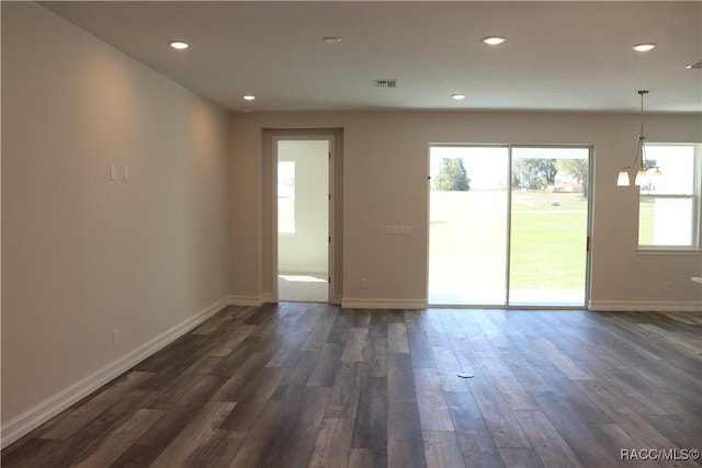 unfurnished room featuring dark wood-style floors, recessed lighting, visible vents, and baseboards