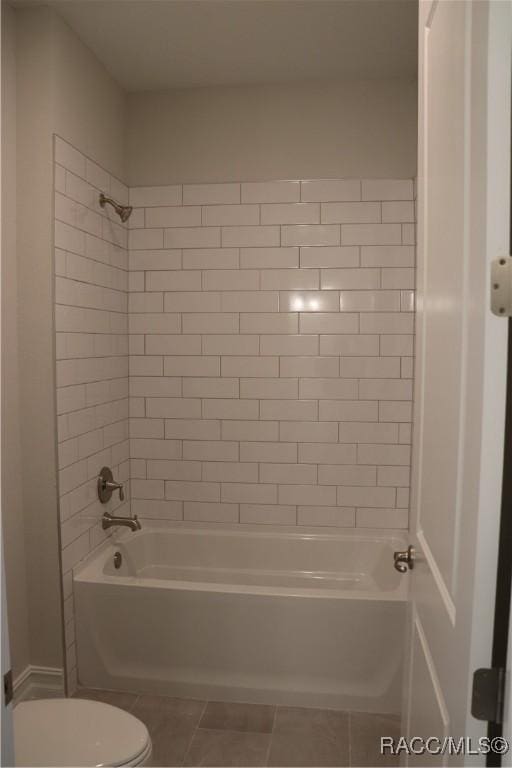 full bathroom featuring toilet, shower / tub combination, and tile patterned floors