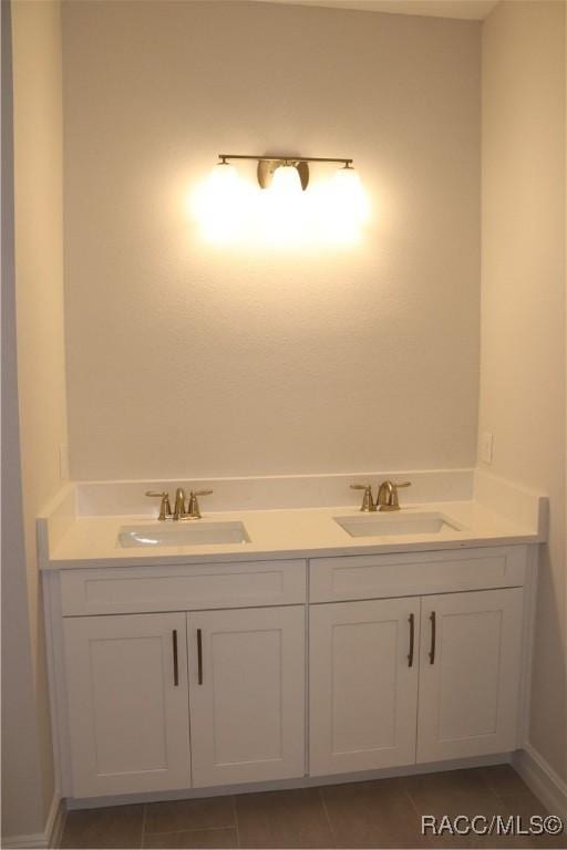 bathroom featuring double vanity, tile patterned flooring, and a sink