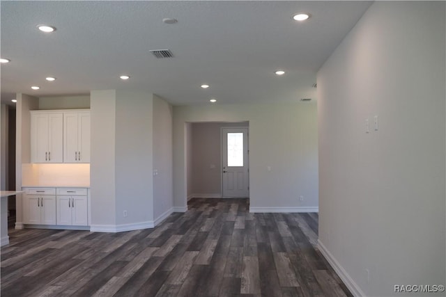 interior space with recessed lighting, dark wood finished floors, visible vents, and baseboards