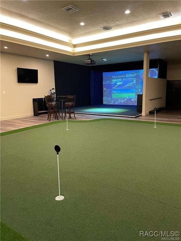 rec room with a raised ceiling, golf simulator, carpet flooring, and a textured ceiling