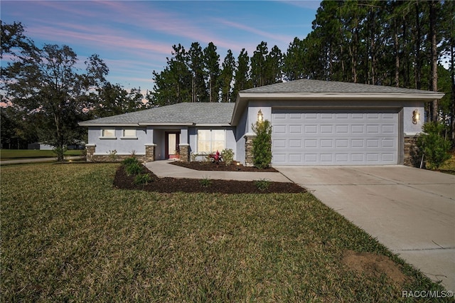 view of front of home featuring a garage and a lawn