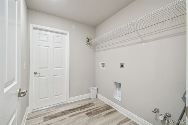 washroom with electric dryer hookup, hookup for a gas dryer, washer hookup, and light wood-type flooring