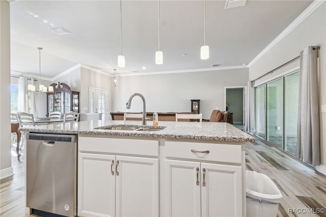 kitchen with white cabinets, stainless steel dishwasher, sink, and hanging light fixtures