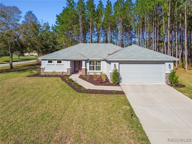 single story home featuring a garage and a front lawn