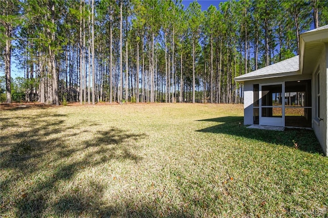 view of yard with a sunroom