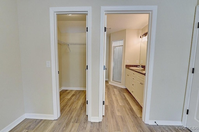 bathroom featuring walk in shower, vanity, and hardwood / wood-style floors