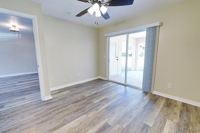 empty room with a textured ceiling, ceiling fan, and wood-type flooring