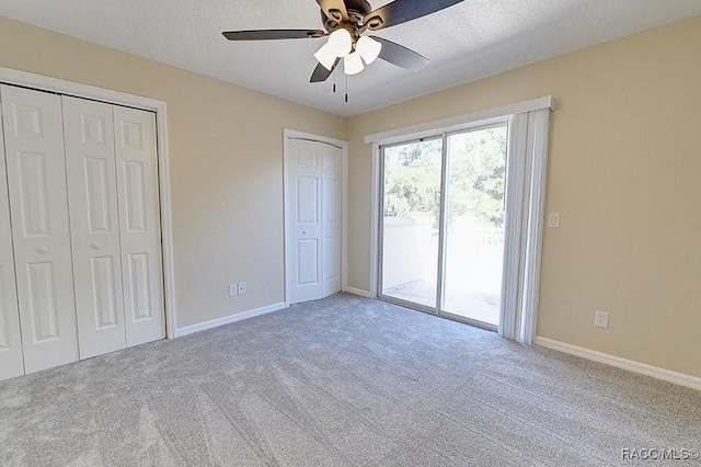 unfurnished bedroom featuring a textured ceiling, ceiling fan, access to exterior, and light colored carpet